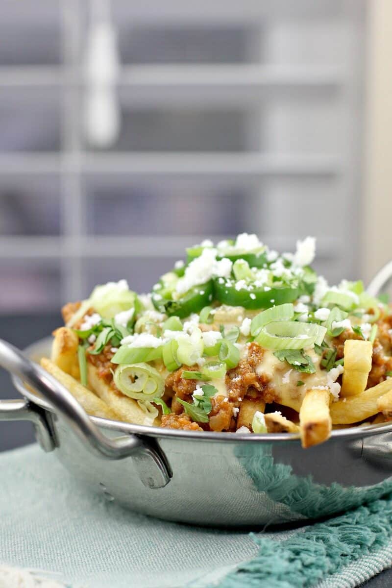 poutine in a dish on a blue napkin