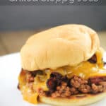image for pinterest sloppy joe sandwich with text overlay of recipe title Bacon Cheddar Beer Grilled Sloppy Joes