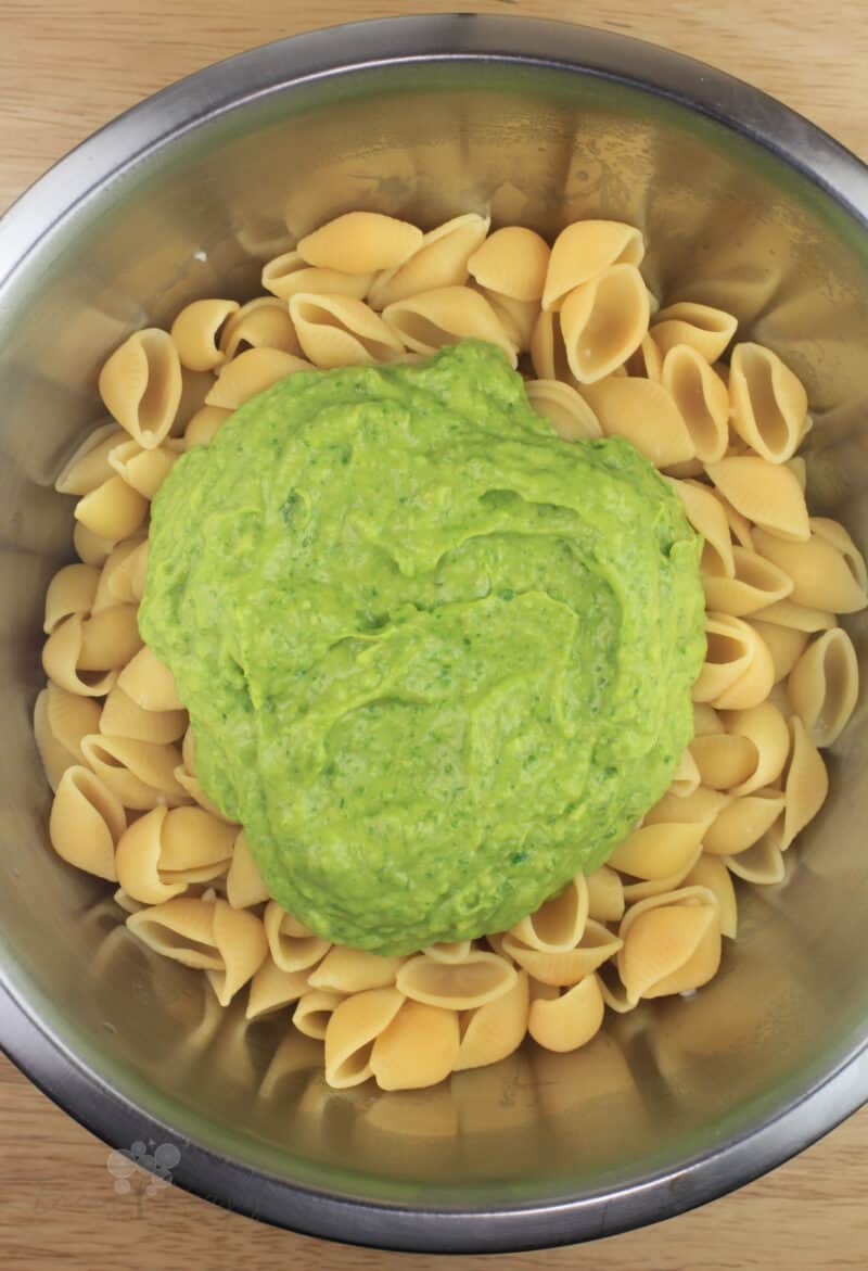 metal bowl with pasta and avocado pasta sauce poured on top