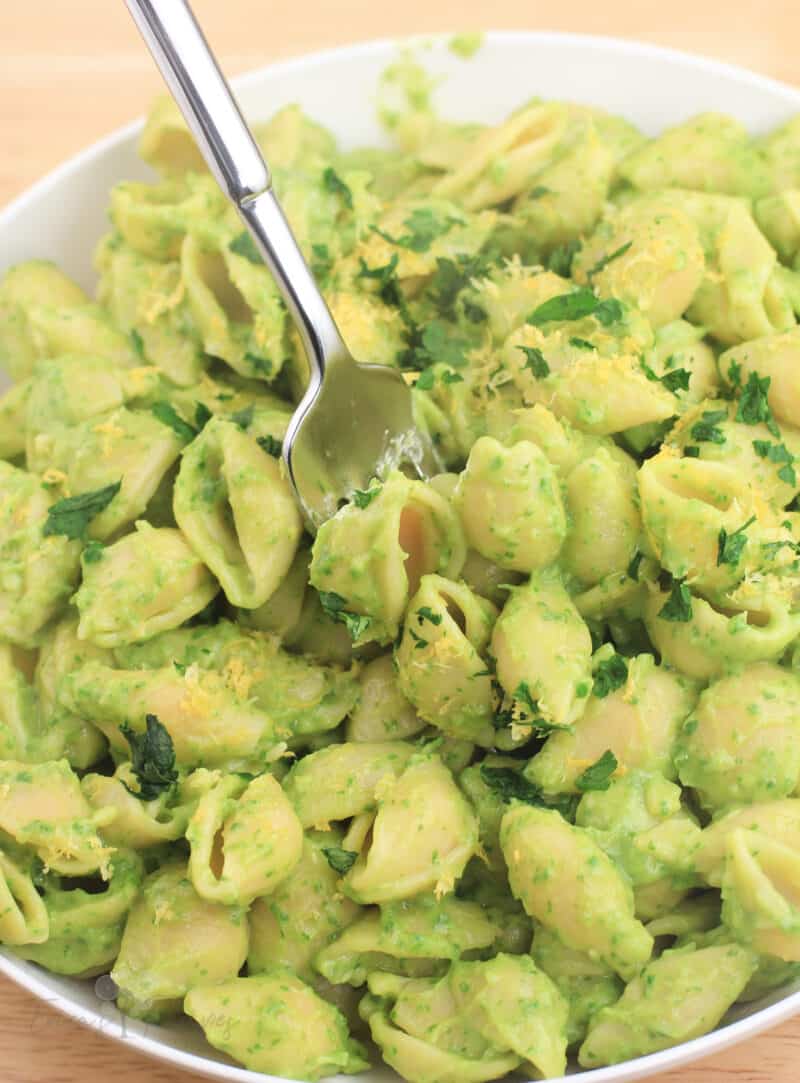 close view of avocado spinach pasta with a fork