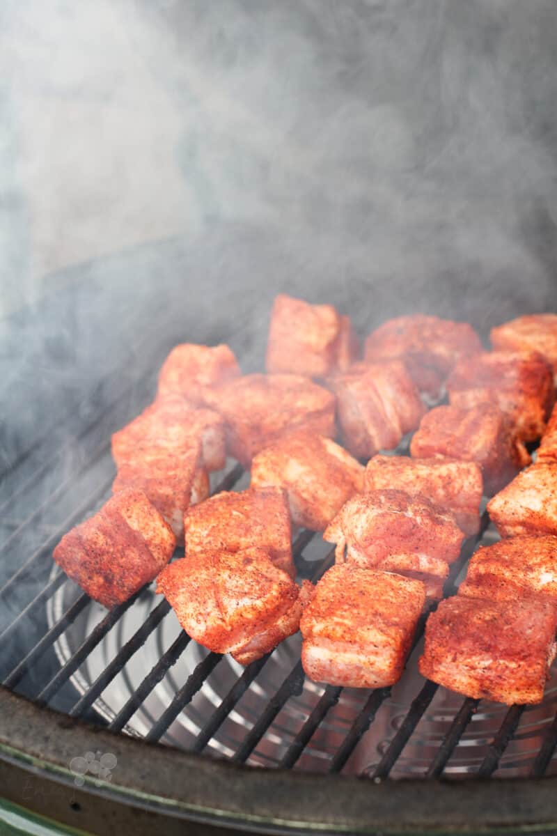 uncooked pork belly on grill grate