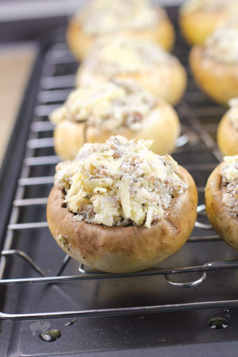 uncooked stuffed mushroom on grate