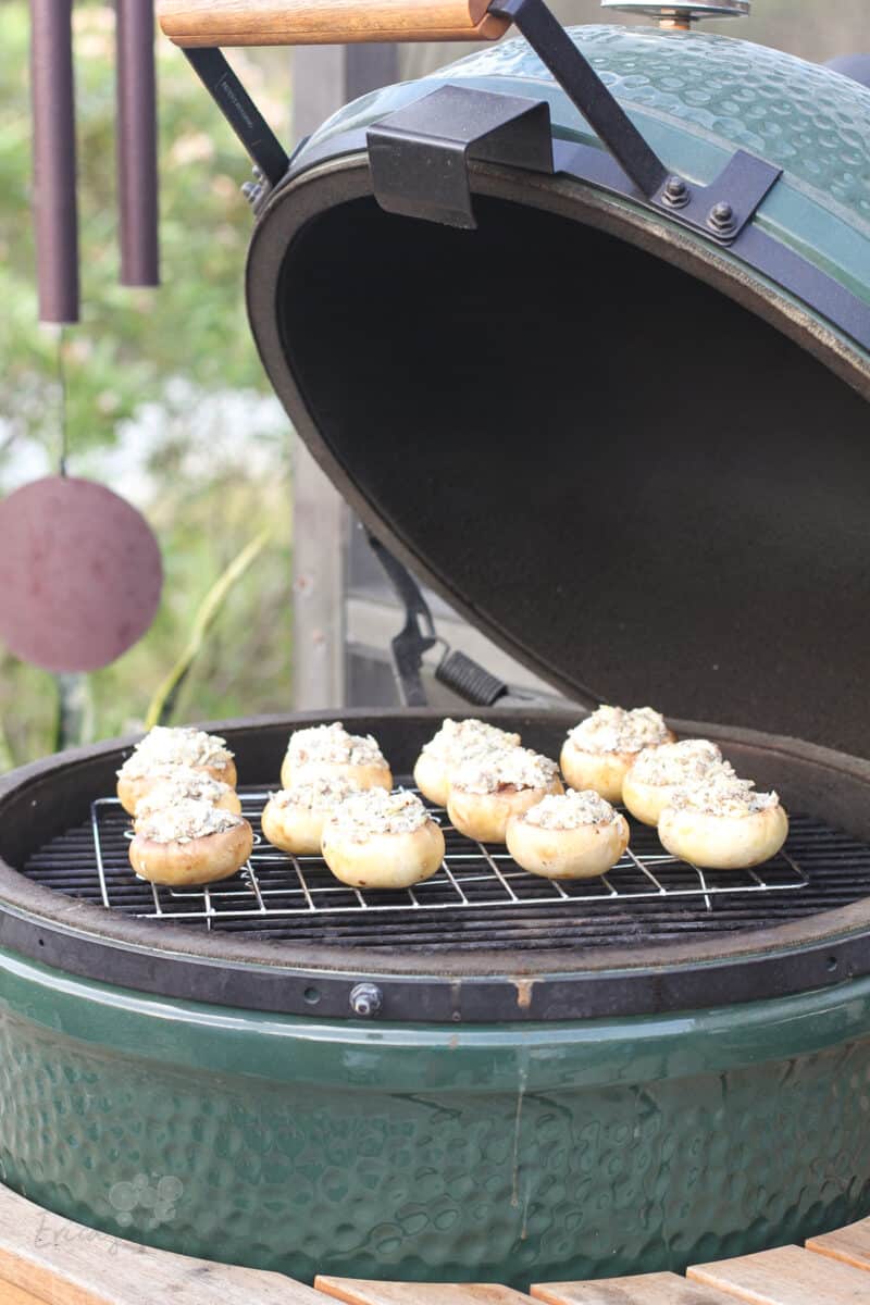 Big Green Egg open with mushrooms in on grill grate