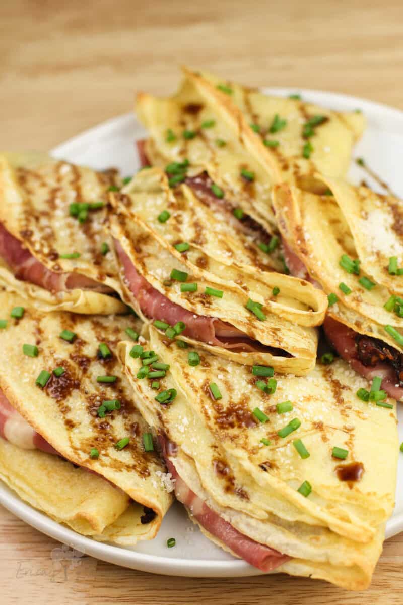 angled view of crespelle showing prosciutto inside