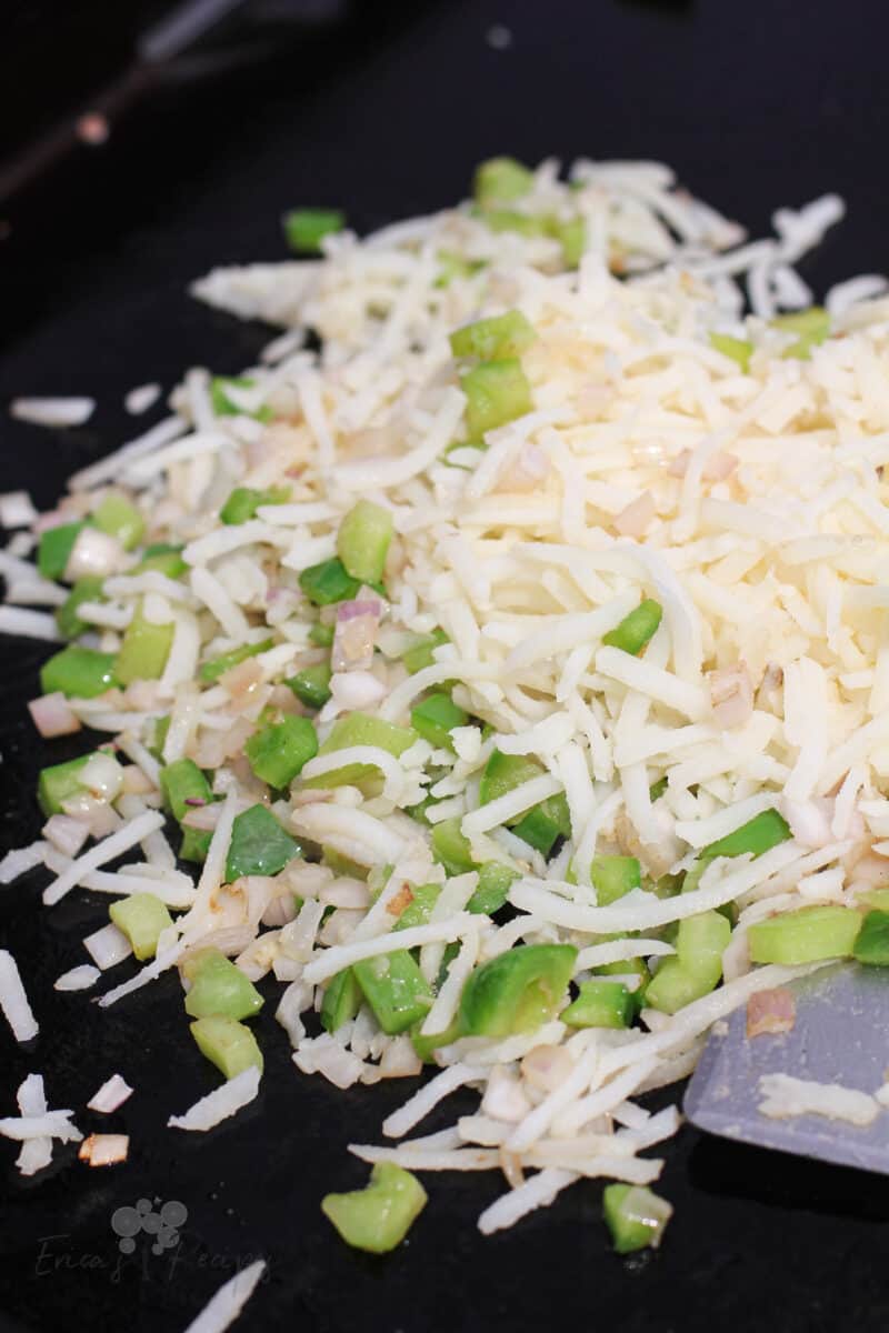 raw potato and bell pepper on black griddle surface