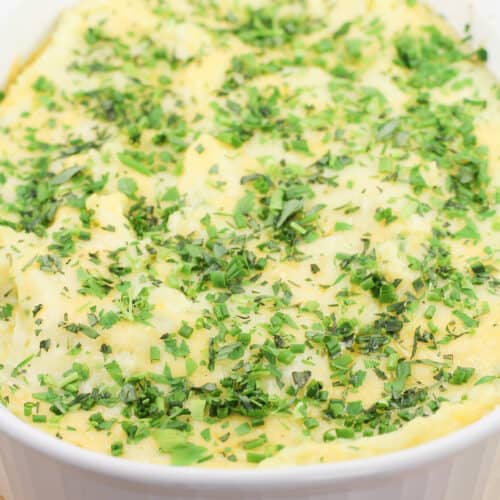 top, angled view into white dish of prepared guyere, garlic, and gouda mashed potatoes