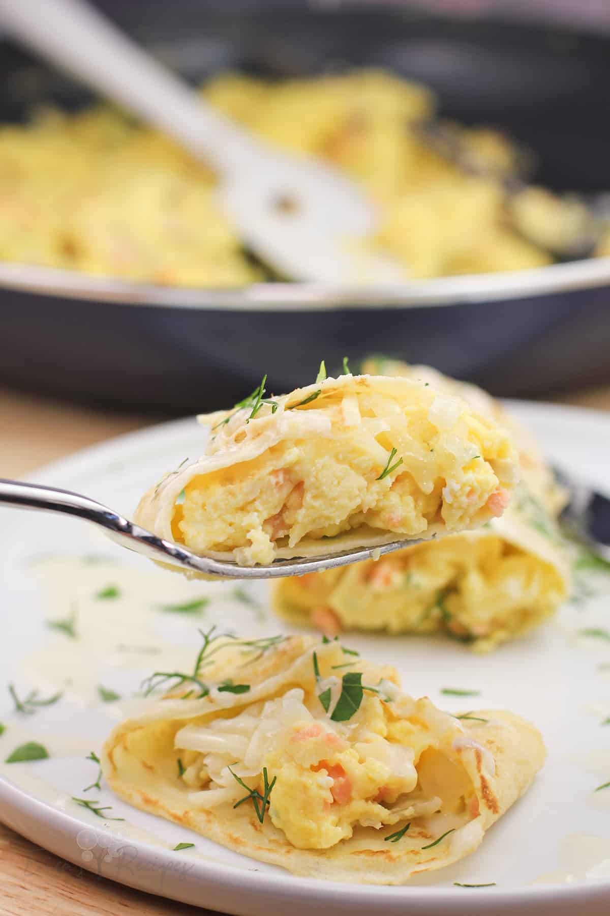 fork holding a bite of crepe to show the egg filling