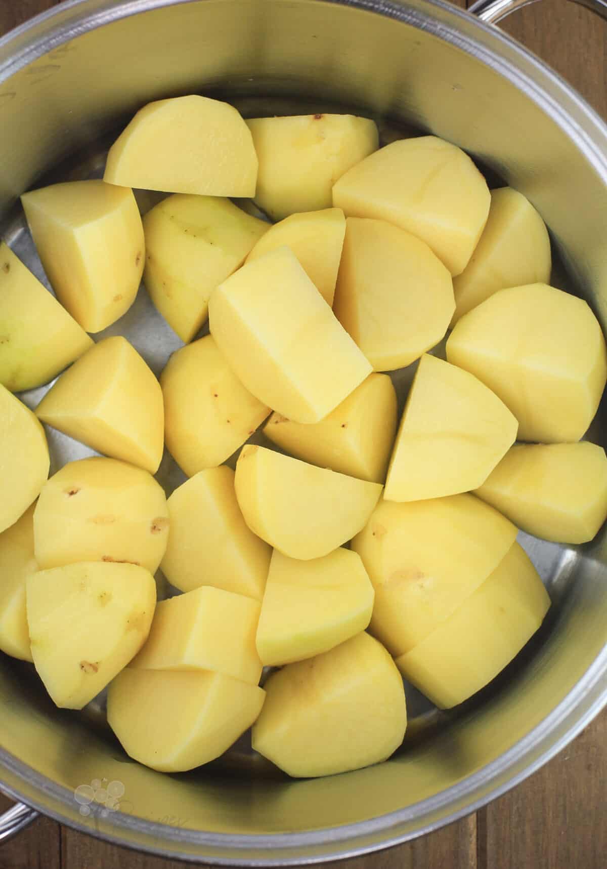 cut potatoes in pot