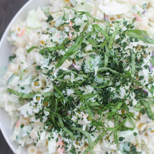 prepared salad in white bowl on weathered wood background