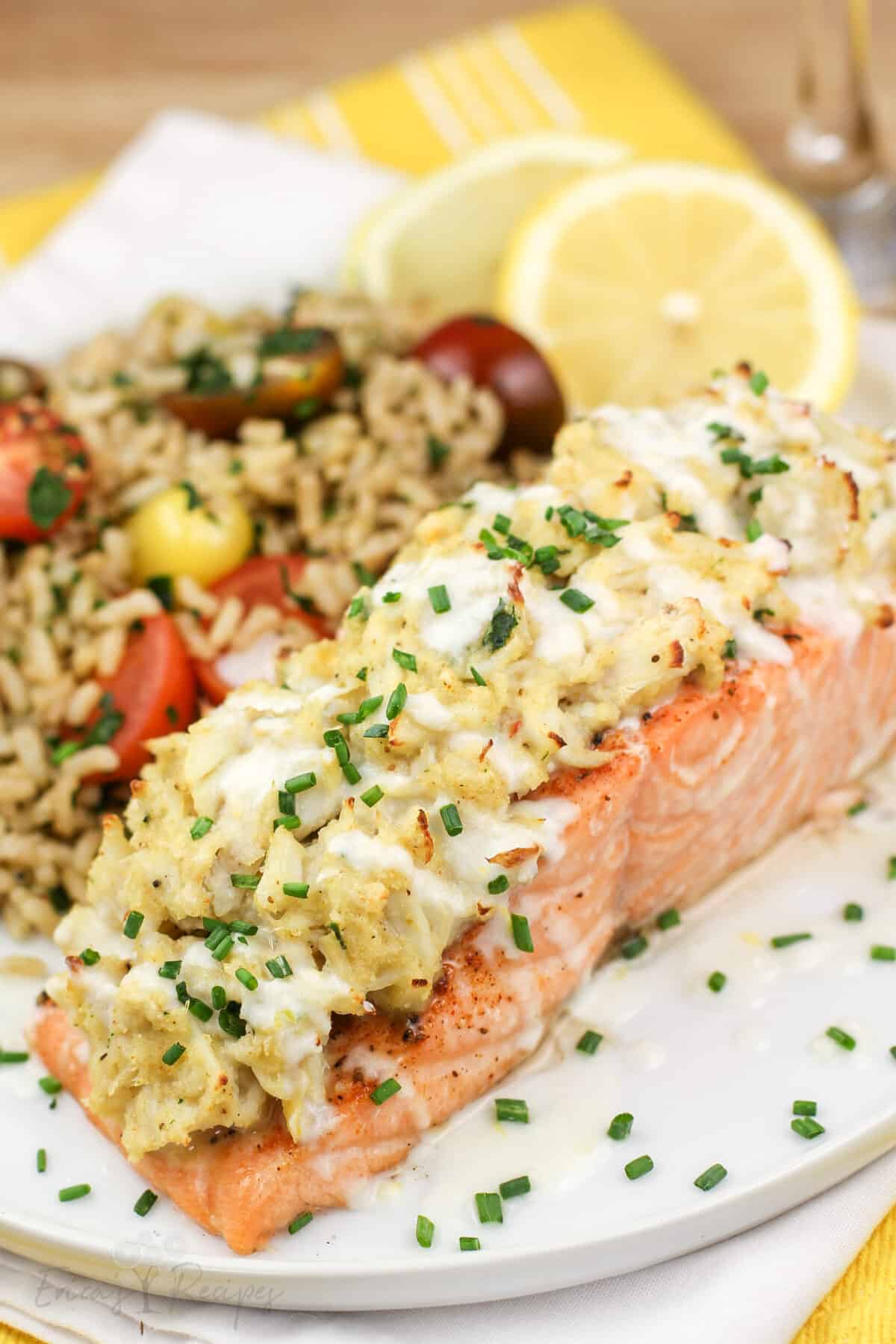 plated portion or salmon on white late with lemon and brown rice