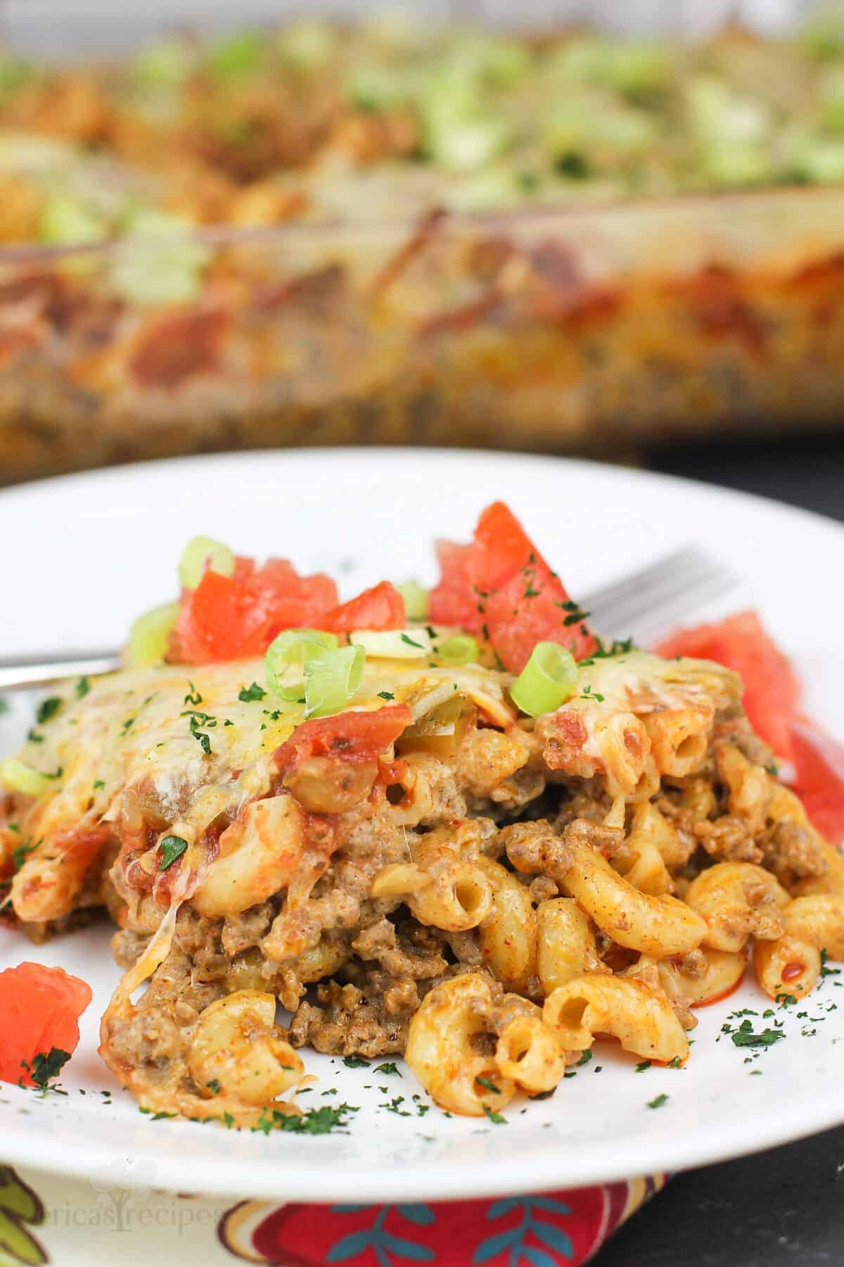 plated recipe on white dish with casserole in background