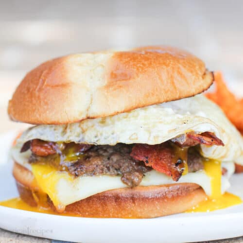 bacon and egg burger on white dish