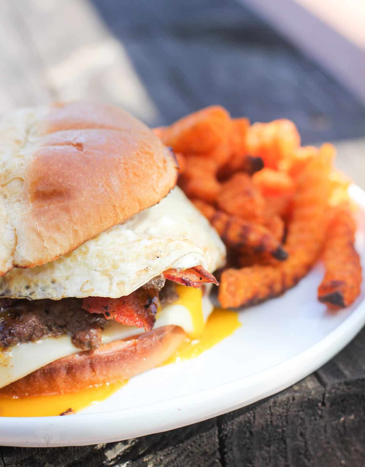 prepared hangover burger on plate with sweet potato fries