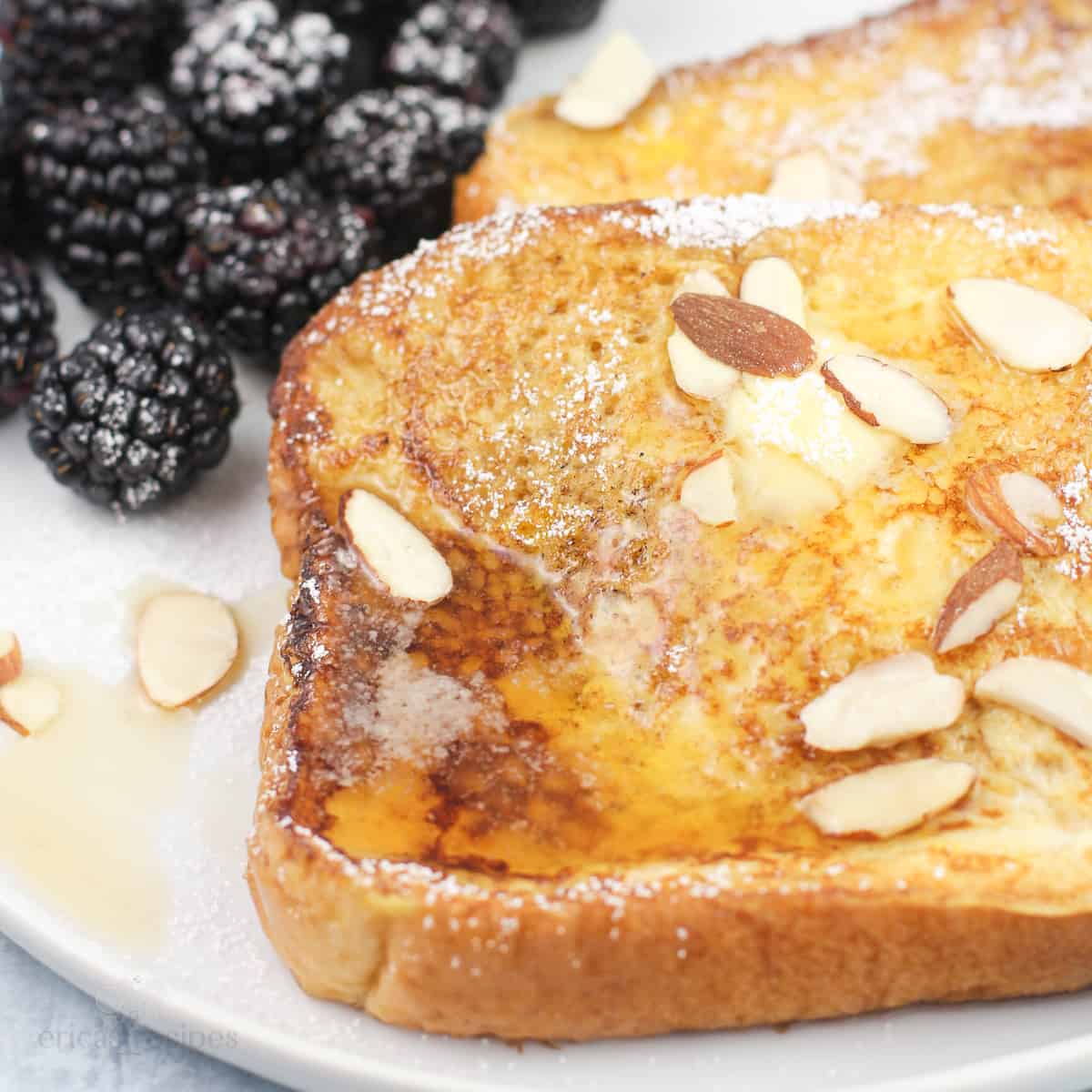 Blackstone French toast with amaretto on white plate with blackberries