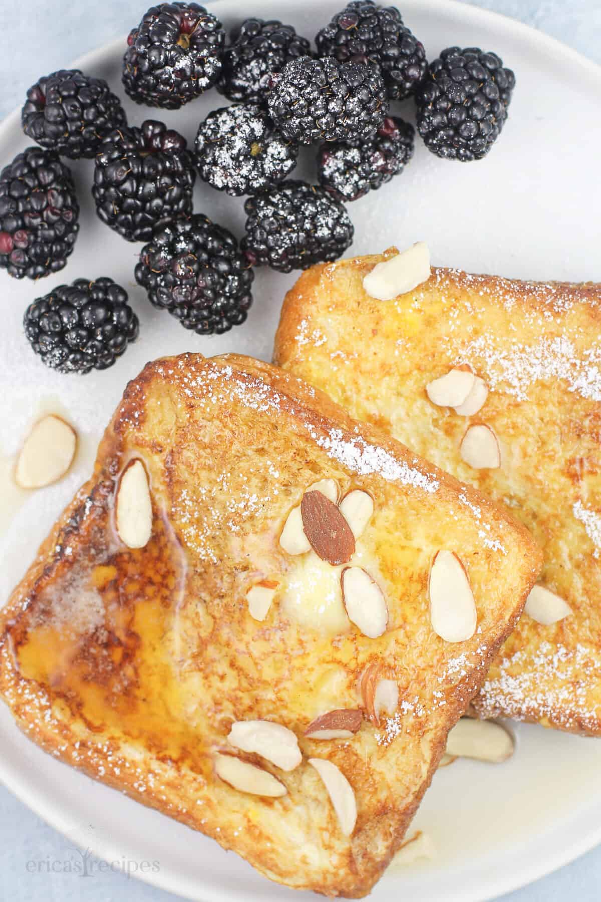 French toast on white plate with blackberries