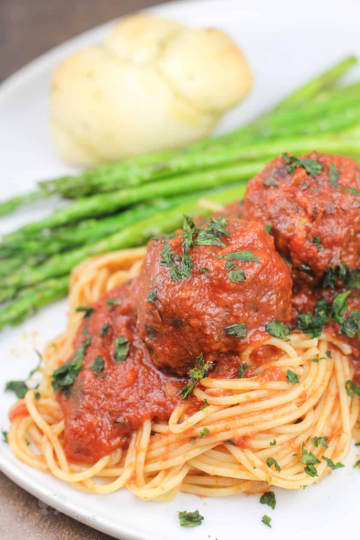 plated recipe on white dish with asparagus