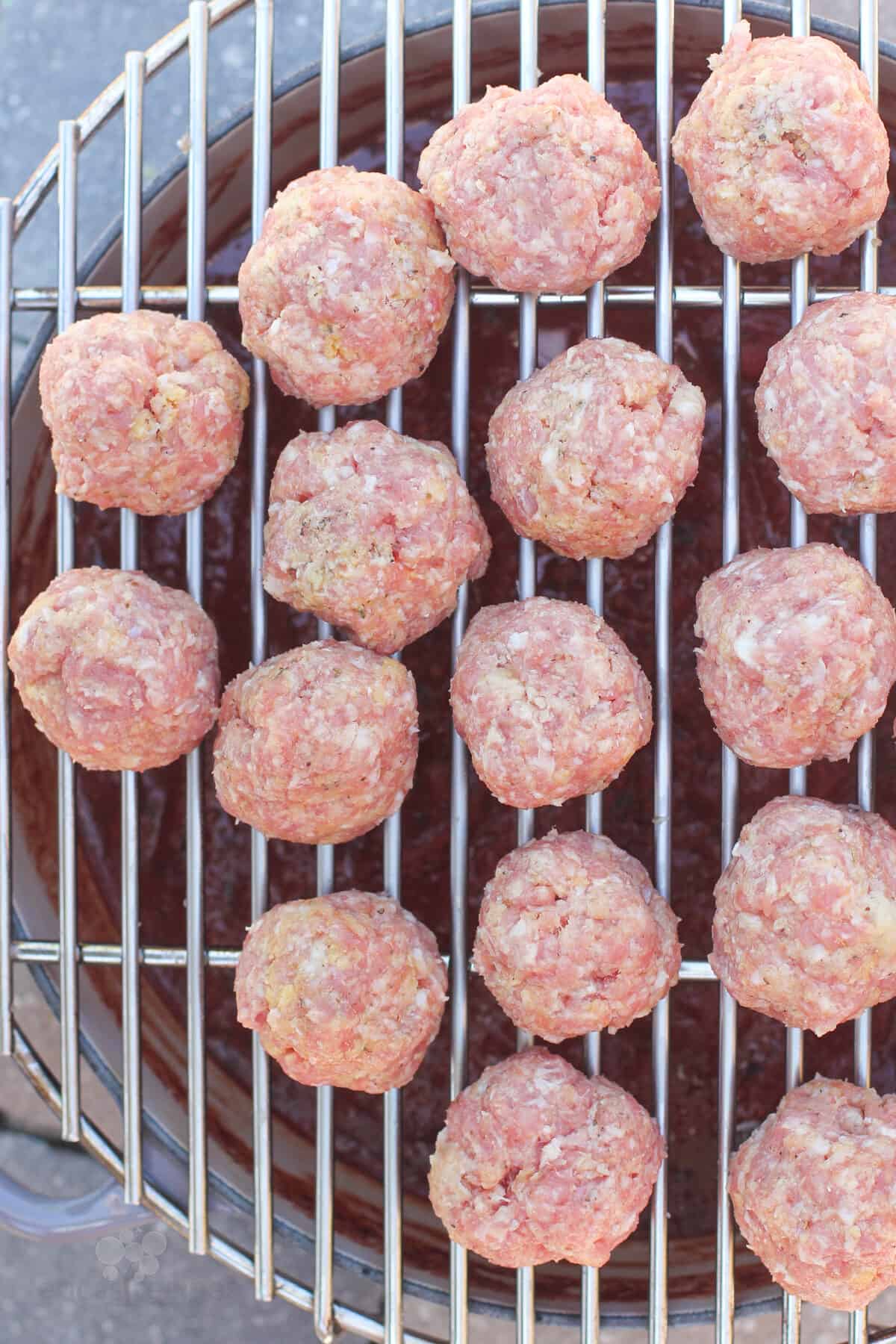 uncooked meatballs on grill rack