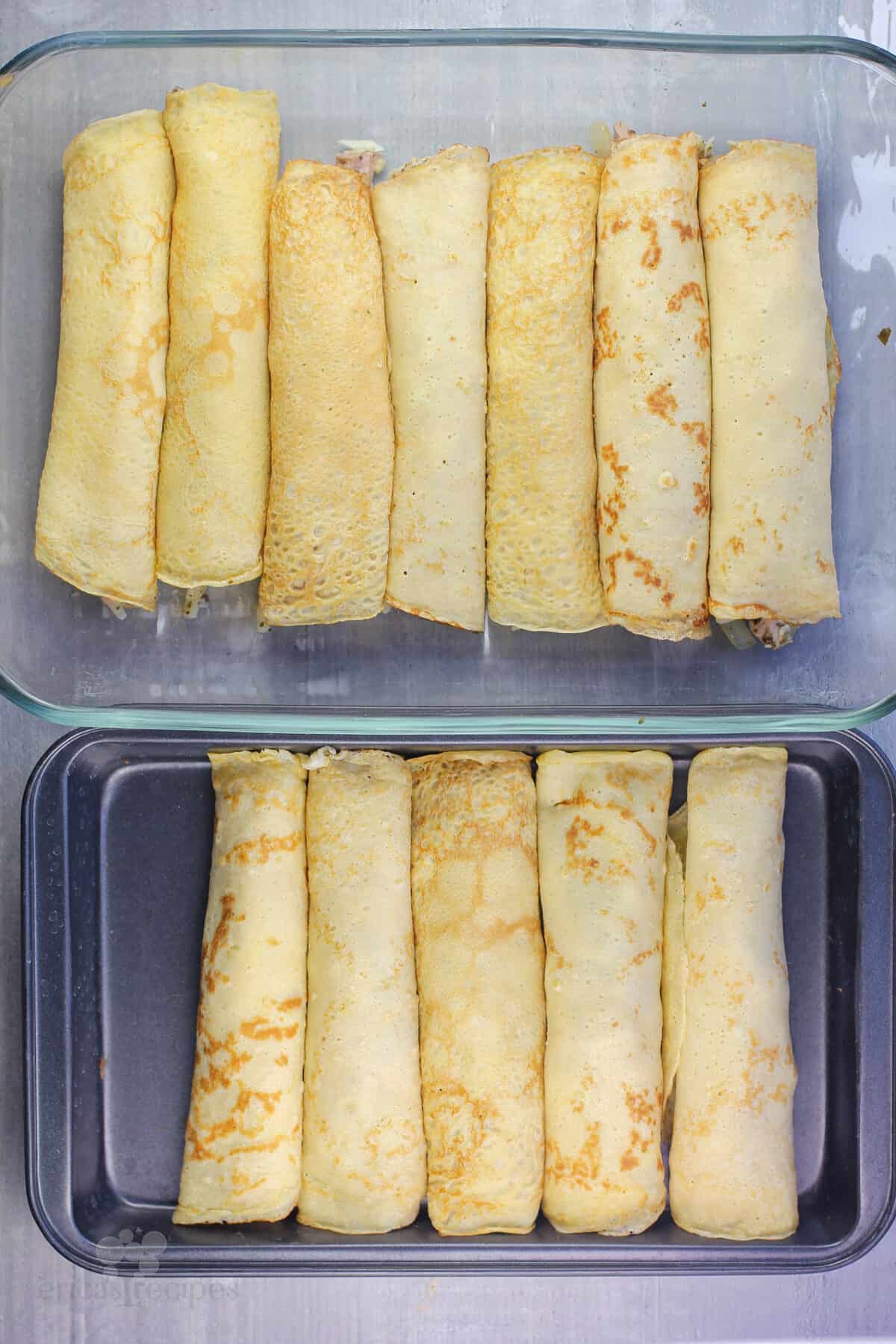 two pans filled with assembled crepes