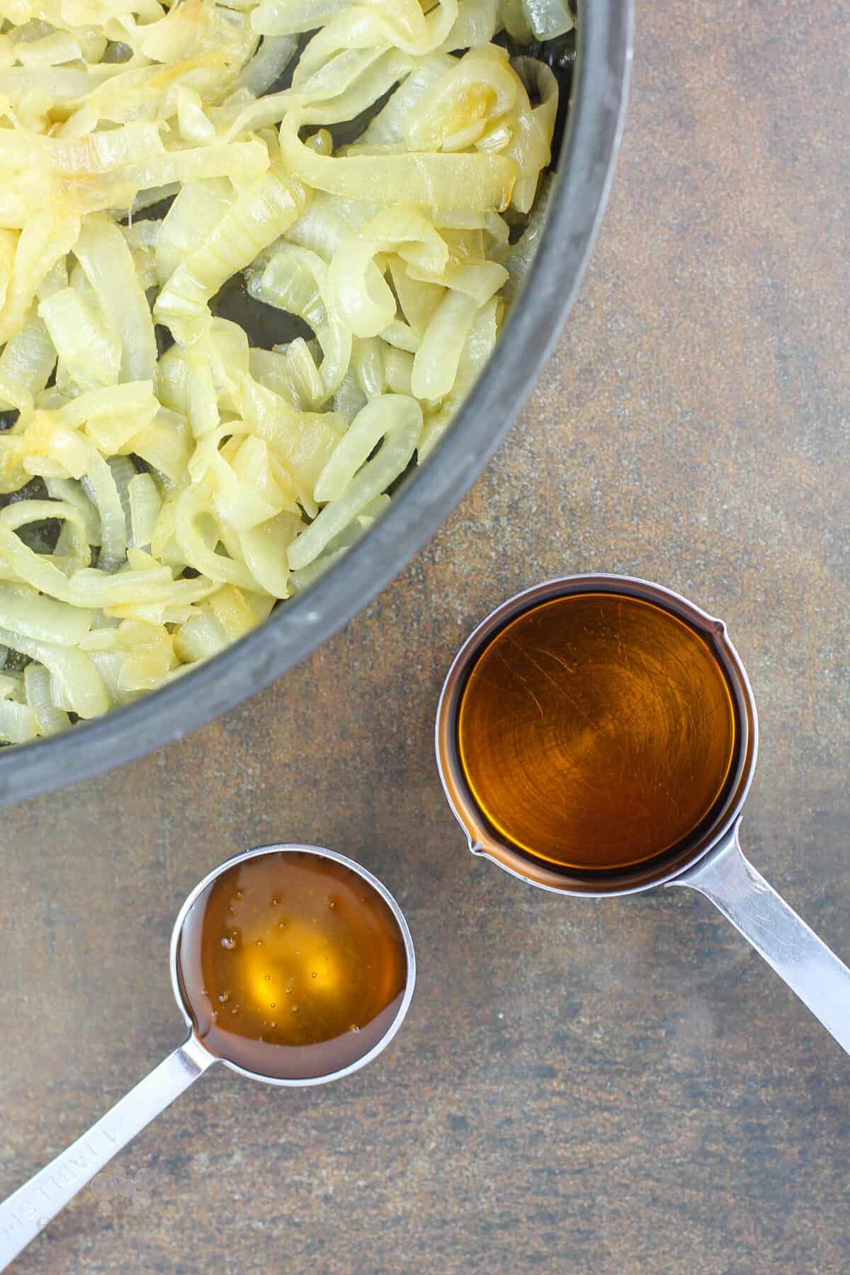 measuring cups with honey and bourbon
