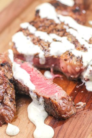 cut steak topped with cream sauce