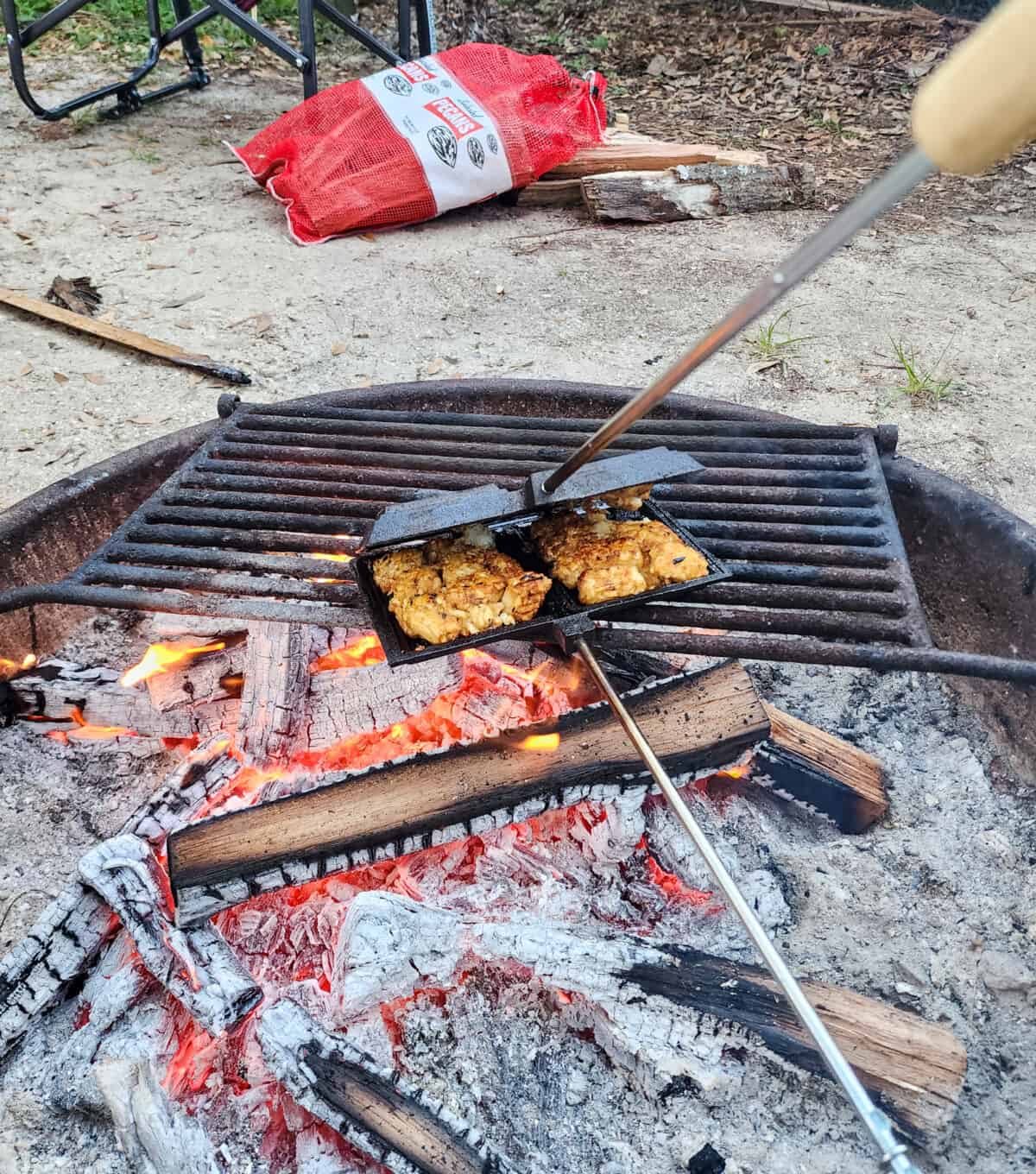 pie iron over hot coals in a campfire