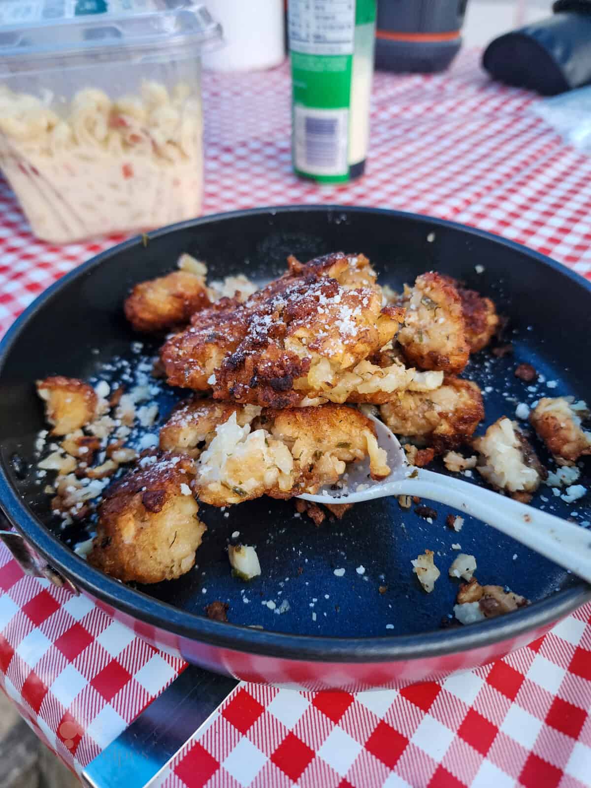 prepared tater tots on dish with spoon