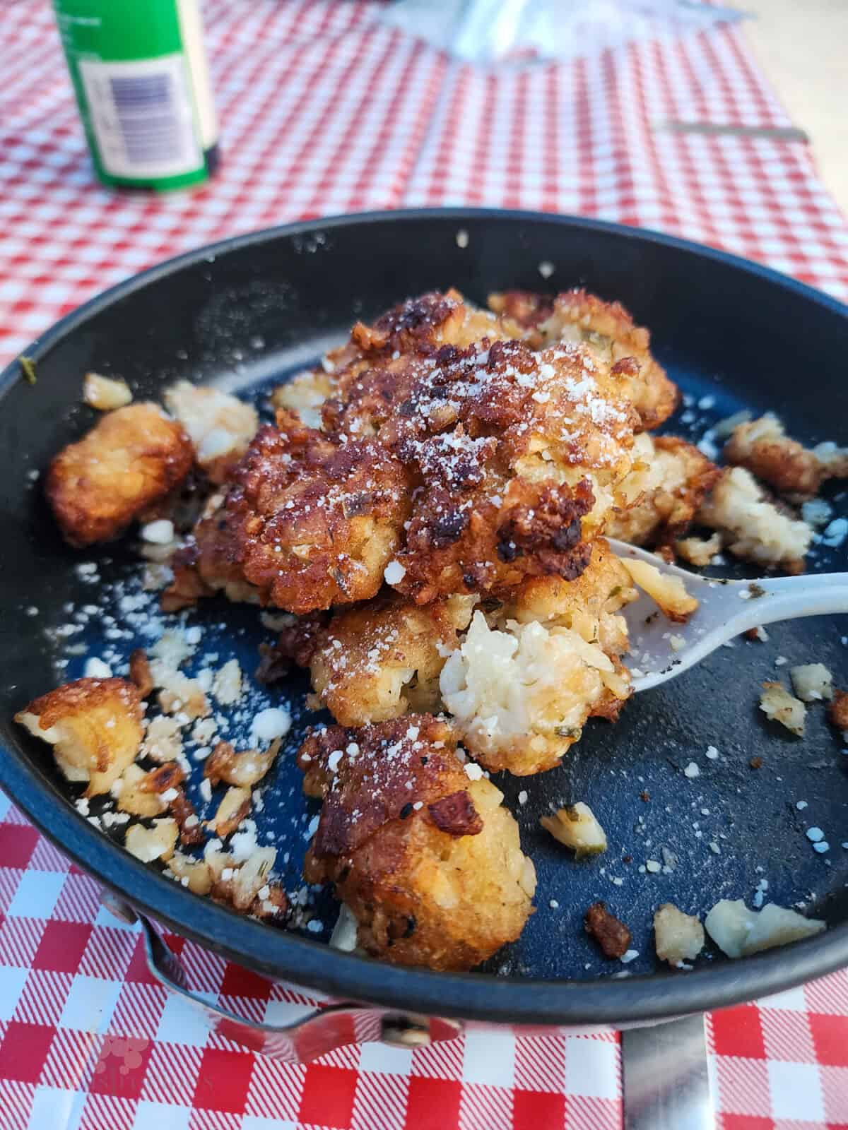 prepared taters on dish with spoon