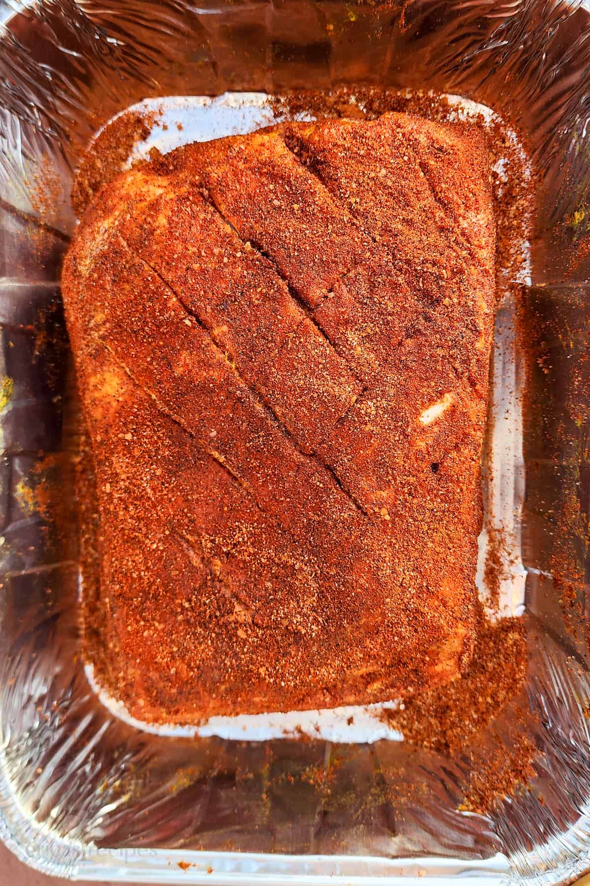 prepped and seasoned Boston butt in pan