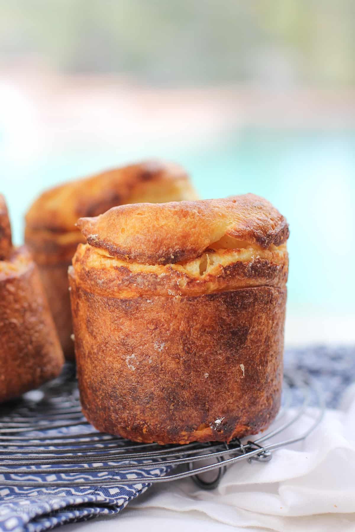 prepared garlic parmesan popover on rack over blue napkin