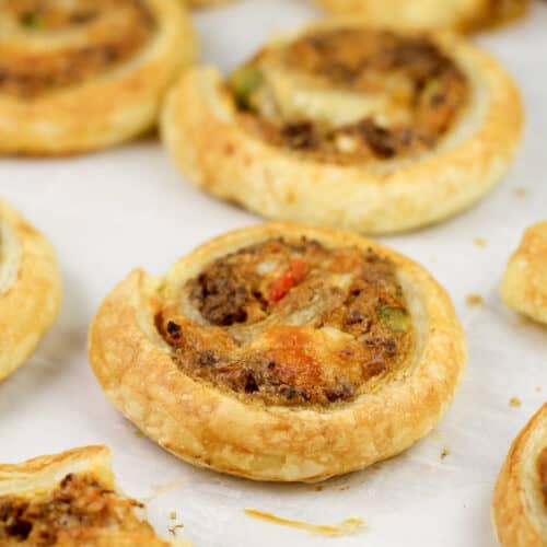 cooked puff pastry taco pinwheels on parchment paper