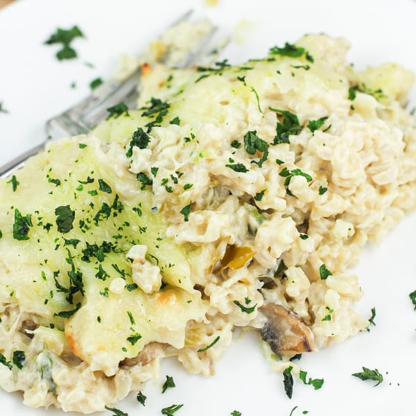 rice casserole on white dish topped with cheese and herbs